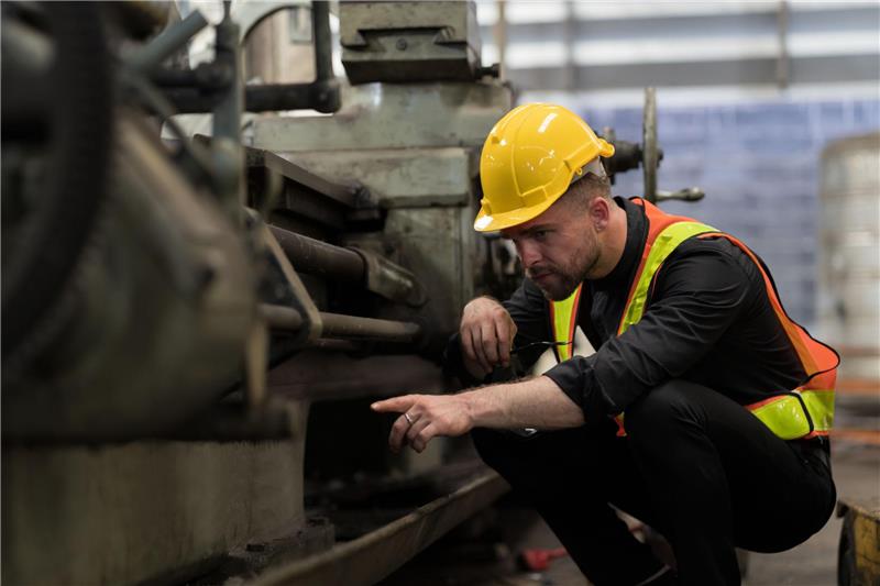 Safety worker inspecting equipment on the line